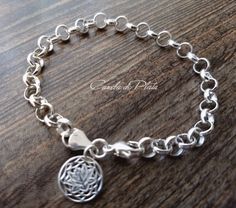 It is made with link 6.6mm rolo chain sterling silver lotus flower charm of 13 mm. and lobster clasp 13mm. This bracelet looks gorgeous on your wrist. A classic that never outdated. Handmade. All componenetes of this bracelet are sterling silver Not plated No extra charge for extra items. One flat fee for your entire purchase It is sent in a nice gift box by registered mail with tracking number. Thanks for visiting Caneladeplata. Sterling Silver Charm Bracelet With Rolo Chain, Sterling Silver Charm Bracelet With Rolo Chain For Gift, Silver Charm Bracelet With Rolo Chain For Gift, Sterling Silver Rolo Chain Charm Bracelet Gift, Round Rolo Chain Charm Bracelet As Gift, Chain Charm Bracelet, Belly Chain, Bracelet Sterling Silver, Rolo Chain