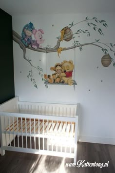 a baby's room with winnie the pooh mural