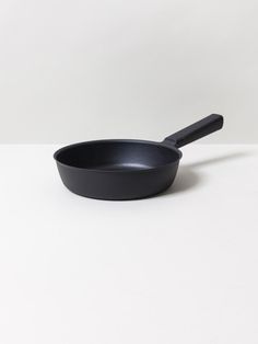 a black frying pan sitting on top of a white table