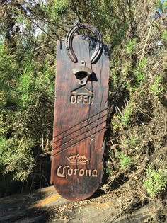 a wooden sign that says open with an antelope on it's head