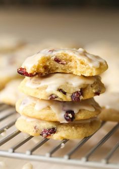 a stack of cookies with icing and cranberries