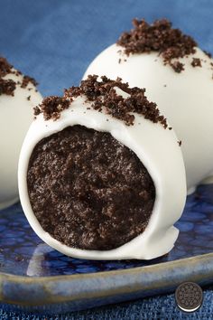 two chocolate covered desserts on a blue plate