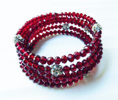 "This is a Memory Wire bracelet. 3 inches in diameter with a luxurious five loop design.  Fits a medium to ex large wrist with an easy on easy off nature. Just a great \"go to\" bracelet to wear both casually or formally. 6mm RUBY RED Czech crystal rondelles with 7, 9mm rhinestone ball beads. thanks for looking!" Red Memory Wire Bracelet, Loop Design, Memory Wire Bracelet, Ruby Crystal, Memory Wire Bracelets, Czech Crystal, Memory Wire, Wire Bracelet, Ruby Red