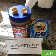 a jar of peanut butter next to a sign with the word skippy written on it