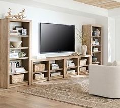 a living room filled with furniture and a flat screen tv on top of a wooden entertainment center