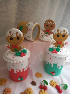 there are some cupcakes that have been decorated to look like people in christmas outfits