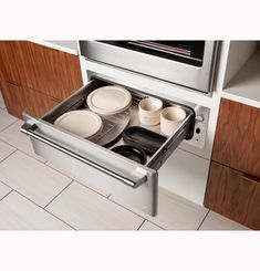 an open dishwasher drawer in a kitchen