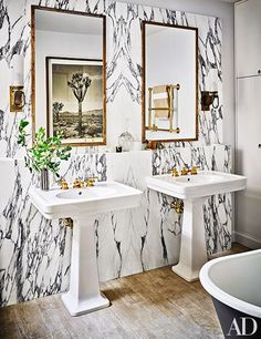 two white sinks sitting next to each other in a bathroom