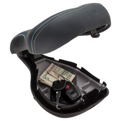 a car seat with money and keys in the back pocket, on top of a white background