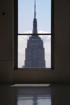 the empire building is seen from an empty room with no one in it's place