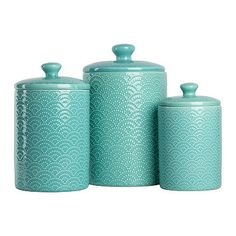 three blue canisters with lids and handles