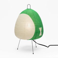 a green and white lamp sitting on top of a table