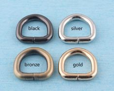 three different types of metal buckles on a blue surface with the words black, silver, and bronze