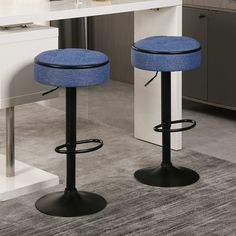 two blue stools sitting in front of a kitchen counter