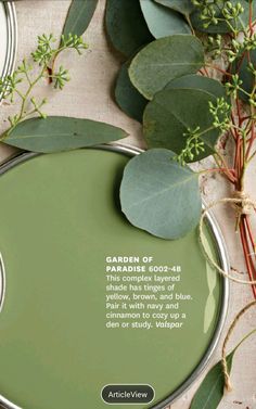 an advertisement for garden products on a table with eucalyptus leaves and greenery in the background