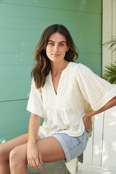 The Tulum top from Australian brand Little Lies is a perfect staple for spring/summer. Features pleated detail on the front, a flattering square sleeve and a v-neckline. This gorgeous top is an oversized fit that can be paired with your favorite pants or shorts. Semi-sheer. Materials: 100% Cotton Care: Wash with like colors; cold gentle machine wash; do not bleach; lay flat to dry; warm iron; do not tumble dry. Size Info: Model is 5'8" and is wearing a size S; relaxed fit Size Guide | Shipping Policy Casual Short Sleeve V-neck Top For Brunch, White V-neck Top For Summer Vacation, Effortless V-neck Blouse For Day Out, Summer Cotton V-neck Top For Day Out, Versatile V-neck Blouse For Beach, Relaxed V-neck Blouse For Day Out, Chic Spring Top With Notched Neckline, Chic Tops With Notched Neckline For Spring, Spring Top With Notched Neckline For Day Out