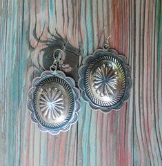 Vintage Native American Navajo handcrafted. These large pierced, Sterling Silver concho style Earrings are stunning works of art; the style is slightly concave, not flat in other words. While they do make a statement, the style is classic and casual; think of the series Yellowstone... This is that perfect gift for the discerning buyer looking for a quality signature look. Measurements: 2 x 1 1/2" Tested For Sterling Native American Navajo Handmade Vintage, never worn Native American Silver Earrings, Vintage Navajo Earrings, Vintage Native American Jewelry Stone, Southwestern Style Nickel-free Brown Earrings, Nickel-free Blue Southwestern Earrings, Vintage Jewellery Rings, Concho Belt, Pendant Watches, Vintage Navajo