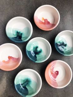 six small bowls with different designs on them