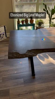 a table that is made out of wood and has the words ebonized big leaf maple on it