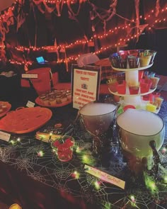 a table topped with bowls and plates covered in candy canes on top of a table