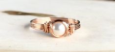 This ring features a flawless, beautiful 6mm Swarovski Pearl, wire wrapped in 14k Rose Gold Filled wire. Perfect for everyday wear, or for a special occasion! This ring would make a beautiful engagement ring, wedding ring, or bridal gift. Pearl is also one of the Birthstones for June. This can be made in any size, from 2-15, in whole, half, or quarter sizes. Click here to see this ring in 14k Gold Filled: https://www.etsy.com/listing/451985674/pearl-ring-gold-wire-wrapped-ring-14k?ref=shop_home_ Rose Gold Wire Wrapped Rings For Wedding, Rose Gold Wire Wrapped Wedding Rings, June Birthstone Ring, Beautiful Engagement Ring, Gold Pearl Ring, Wire Wrapped Ring, Ringe Gold, Gold Filled Ring, Beautiful Engagement Rings