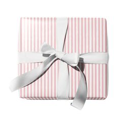 a pink and white striped gift box with a bow