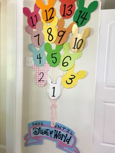 a door decorated with paper cutouts and numbers for the day's unit at disney world