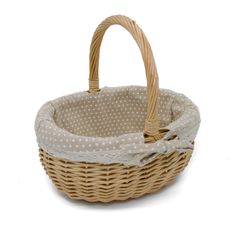 a wicker basket with white polka dots on the front and bottom, sitting on a white background