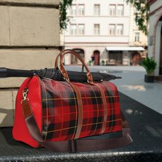 Beautiful plaid printed travel bag. Made with high-grade waterproof fabric, it's a highly durable means of transferring your essentials wherever you go. With multiple compartments, a resilient carrying handle, and an adjustable shoulder strap, it's the perfect companion for all your adventures.  .: 100% high-grade PU leather .: One size: 20" × 12'' × 9" (50.8cm × 30.5cm × 23cm ) .: Brown PU leather handles and an adjustable shoulder strap .: Polyester lining .: Gold-colored zipper  .: All-over printImages by [Zlatko Guzmic, Zlatko Guzmic, Zlatko Guzmic, Zlatko Guzmic / Shutterstock]Images by [vector punch, vector punch, vector punch, vector punch / Shutterstock]Images by [vector punch, vector punch, vector punch, vector punch / Shutterstock]Images by [vector punch, vector punch, vector pun Large Capacity Red Shoulder Bag For Travel, Red Duffle Bag With Luggage Sleeve For Weekend Trips, Red Travel Bag With Adjustable Strap, Outdoor Red Bags With Zipper Closure, Red Travel Duffle Bag With Luggage Sleeve, Red Weekender Bag For Travel, Red Duffle Bag With Luggage Sleeve For Travel, Red Rectangular Weekender Bag For Trips, Functional Red Duffle Bag For Daily Use