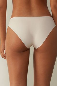 Panties in seamless stretch Supima® cotton. The cotton gusset is applied without seams. Ideal for those looking for items that are invisible underneath fitted clothing. White Seamless High-cut Leg Shapewear, Solid Color Briefs With Minimal Stretch, Seamless Elastane Intimate Briefs, Fitted Clothing, Supima Cotton, Pink Silk, Lingerie Collection, Clothes Collection, Stretch Cotton