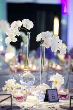 the centerpieces are filled with flowers and candles