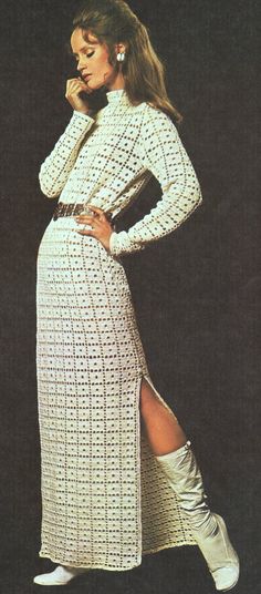 a woman in a white dress and boots posing for a magazine cover with her legs crossed