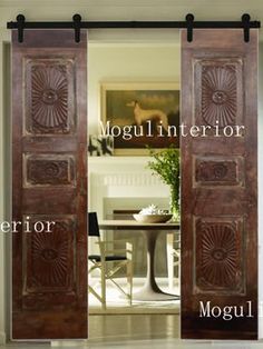 an open door with the words mogul interior in front of it and a dining room table