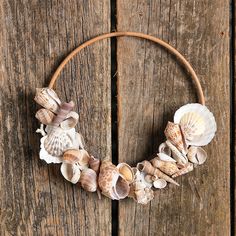 a wreath made out of seashells on a wooden surface