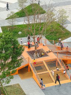 an aerial view of children playing on the playgrounds at a public park in asia