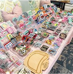 a table topped with lots of assorted stickers and magnets on top of it