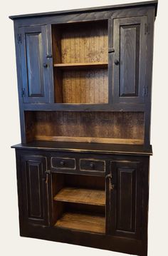 an old black china cabinet with wooden shelves