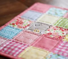 a colorful patchwork quilt on a wooden table