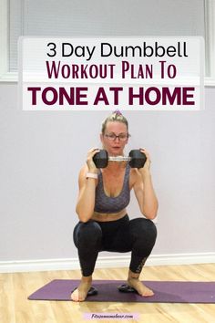 a woman squatting on a yoga mat with dumbbells in front of her