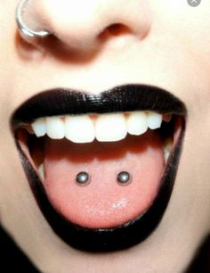 a close up of a person's mouth with a fake tongue and nose ring