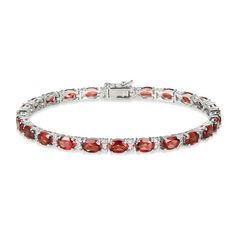 Sumptuous oval-cut garnets adorn this elegant bracelet styled in classic sterling silver. A duo of white lab-created sapphires twinkles between each link for extra sparkle. The 7.25-inch bracelet secures with a box clasp. Classic Oval Gemstone Tennis Bracelet, Red Oval Diamond Classic Bracelet, Red Oval Classic Diamond Bracelet, Classic Red Oval Diamond Bracelet, Elegant Sterling Silver Gemstone Bracelet For Formal Occasions, Classic Sterling Silver Oval Gemstone Bracelet, Classic Oval Gemstone Sterling Silver Bracelet, Classic Sterling Silver Bracelet With Oval Gemstone, Classic Sterling Silver Gemstone Bracelet For Formal Occasions