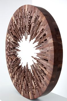 a circular wooden object with many lines on it's sides and a hole in the center