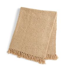 a beige knitted blanket with fringes on the bottom and sides, laying flat against a white background