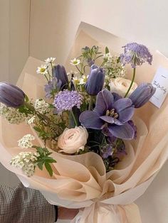 a person holding a bouquet of flowers in their hand