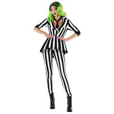 a woman in a black and white striped suit with green hair standing on a white background