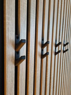 two wooden doors with black handles on them