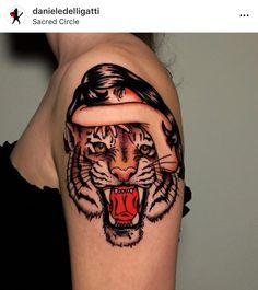 a woman with a tiger tattoo on her arm