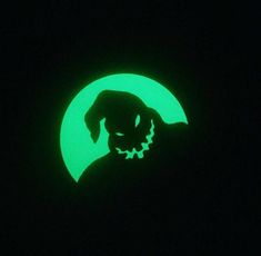 a green glow in the dark with a silhouette of a dog on it's face