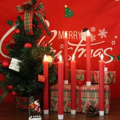 candles are lit in front of a christmas tree