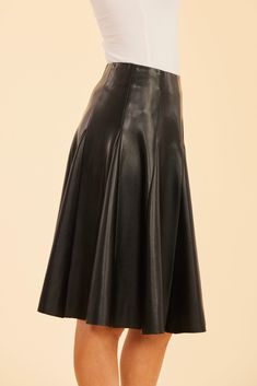 Our Faux Leather Paneled Skate Skirt, designed to blend sophistication and edge, is the perfect addition to your fall wardrobe. This knee-length, faux leather skirt features sleek panels and a flattering pleated silhouette that adds a playful yet structured look. The paneled design creates dynamic movement while offering a chic touch that pairs effortlessly with your favorite boots and sweaters. Faux leather Knee-length Paneled and pleated Available in Black and White Dry clean Style: 75484 Classic Black Skirt For Night Out, Black Leather Skirt For Evening, Sleek Black Skirt For Fall, Black Pleated Skirt For Formal Fall Occasions, Fall Formal Black Pleated Skirt, Black Formal Pleated Skirt For Fall, Fall Evening Skirted Bottoms, Modern Evening Skirt For Fall, Sleek Black Flared Skirt Bottoms